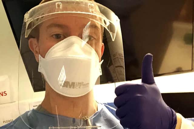 One Royal Navy sailor dressed in full PPE helping at a hospital. Photo: Royal Navy