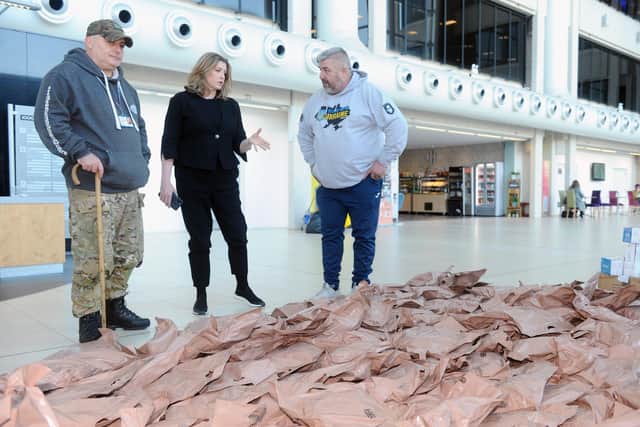 Portsmouth North MP Penny Mordaunt (centre) with more than 300 ration packs bound for Ukraine last week. 

Picture: Sarah Standing (070322-464)