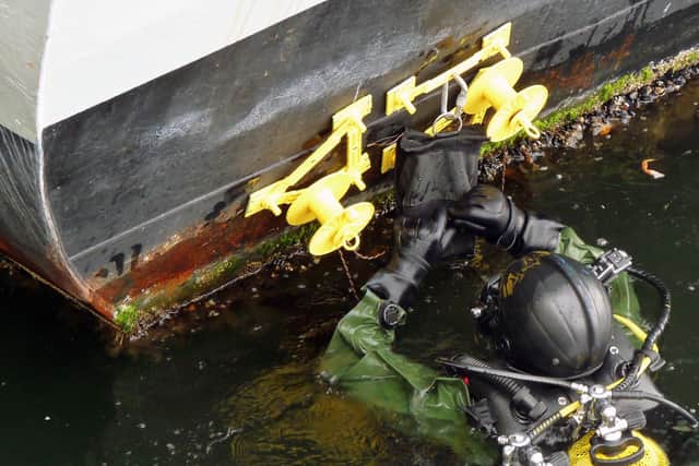 Royal Navy divers have taken part in a multi-national bomb disposal exercise off the West coast of Canada.
Exercise Ardent Defender saw bomb disposal teams from six nations converge on Victoria to teach military and civilian technicians the latest methods in disarming explosive devices.
Eleven divers from Fleet Diving Unit Two – one of the Royal Navy’s three specialist teams – spent the week neutralising, interrogating and gathering intelligence on explosives alongside their diving counterparts.
“This is the first time I’ve been involved in such an intense and challenging exercise. The chance to work with so many other nations and agencies, so far from home, has been really interesting,” said Diver Kieran ‘Charlie’ Dimmock.
“It’s also been extremely rewarding, especially when I was acting as part of a ‘high assurance underwater search team’. We had a good idea that a device had been planted and had to then locate it within a certain time frame and mark it.”
For FDU2 specialises in Improvised Explosive Devices placed in or close to ships and harbour infrastructures. As well as neutralising the bombs – courtesy of personal skill, bravery and a variety of specialist equipment including small remote-controlled vehicles – FDU2 gather as much forensic evidence and intelligence as possible about the device.
“All the nations have similar equipment and do the job in a similar way, but the British are held in high regard due to the fact that we’ve been the leaders in bomb disposal due to lessons learned from Northern Ireland and all the bombs placed over the years by terrorists,” said Lieutenant Commander Sean Heaton, Fleet Diving Unit 2’s Officer-in-Charge.
“The water off Victoria is very similar to Scotland as it is clearer than most harbours, but colder than the south coast of England.”