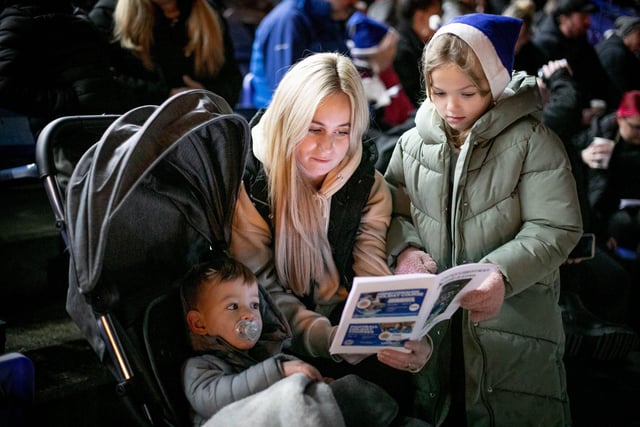 Lisa Howe with Amelia (9) and Noah (1) singing at the event