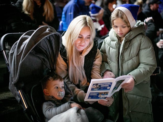 Lisa Howe with Amelia (9) and Noah (1) singing at the event