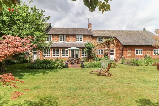 This Hampshire home has seven bedrooms and it is a picturesque house which comes complete with a barn.