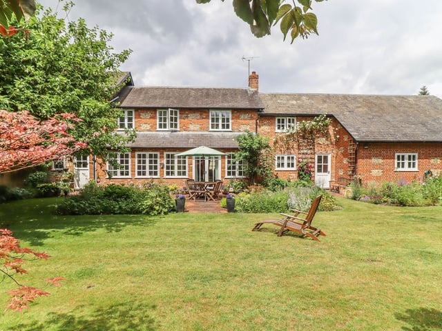 This Hampshire home has seven bedrooms and it is a picturesque house which comes complete with a barn.