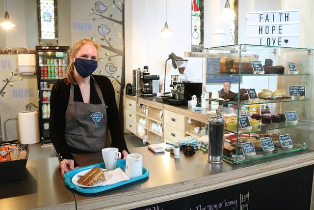 Cafe, shop and foodbank manager Amy Grindlay serves a customer.
Picture: Courtesy of Church of England Diocese of Portsmouth