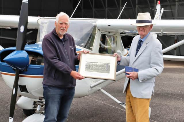 Terry Coombes, Chair of Daedalus Aviation & Heritage Group, with club member David Denison at Solent Airport Daedalus presenting the photograph of his father
