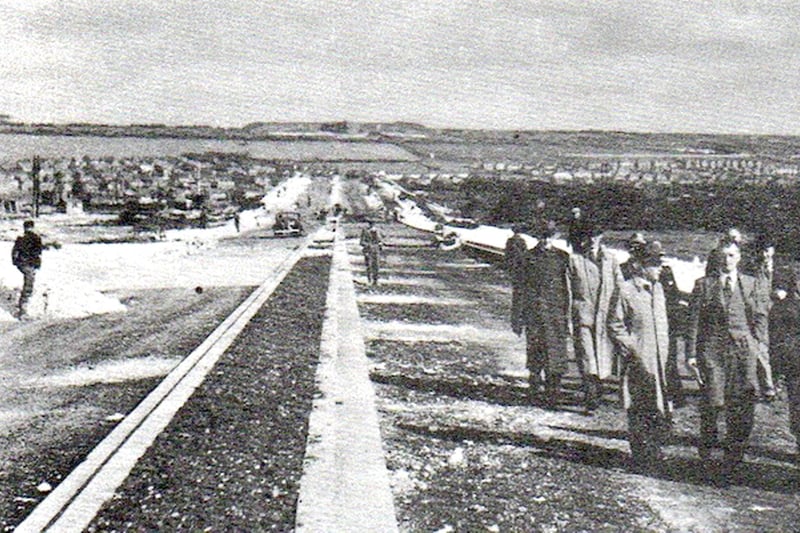 City officials walking the newly ‘completed' Eastern Road.