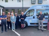 Wally Shufflebottom's family present the Variety Club Sunshine Coach to The Harbour school alongside former England footballer Steve Coppell