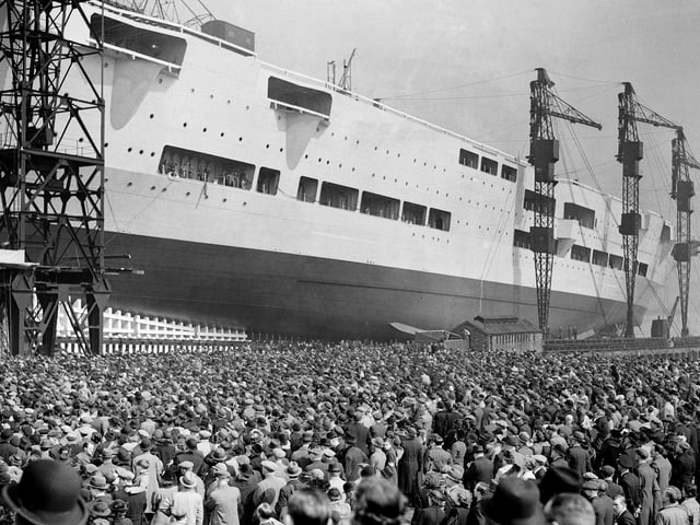 Huge crowds watch as the 22,000-ton aircraft carrier HMS Ark Royal (91) is launched at the Cammell Laird shipyard in Birkenhead, on April 13, 1937. The ship was later sunk off Gibraltar by the German submarine U-81 in November 1941. Picture: Hulton Archive/Getty Images.