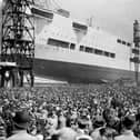 Crowds watch as the 22,000 ton aircraft carrier HMS Ark Royal (91) is launched at the Cammell Laird shipyard in Birkenhead, 13th April 1937. The ship was later sunk off Gibraltar by the German submarine U-81 in November 1941. (Photo by Hudson/Topical Press Agency/Hulton Archive/Getty Images)