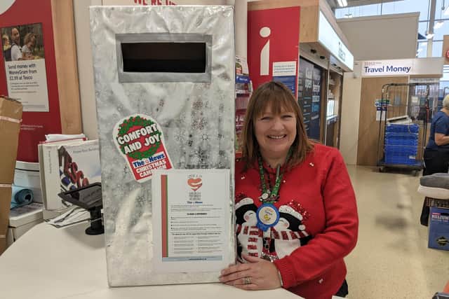 Tesco stores are supporting this year's Comfort and Joy campaign buy housing postboxes for customers to place vouchers into. Pictured: Tanya Hatcher from the Fratton Park store with their postbox