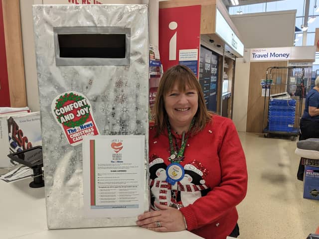 Tesco stores are supporting this year's Comfort and Joy campaign buy housing postboxes for customers to place vouchers into. Pictured: Tanya Hatcher from the Fratton Park store with their postbox