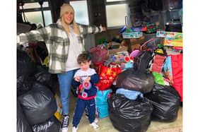 Megan Williams, 29, with her son Marley Wooden, 3, and the donations towards her Christmas hampers for families in need