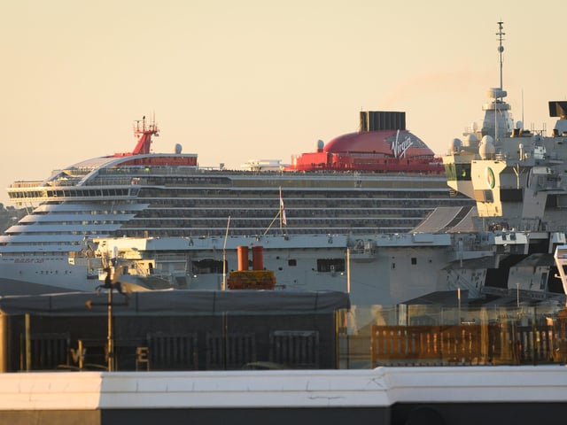 Pictured is: MV Resilient Lady passes behind HMS Queen Elizabeth  Picture: Keith Woodland (140921-11)