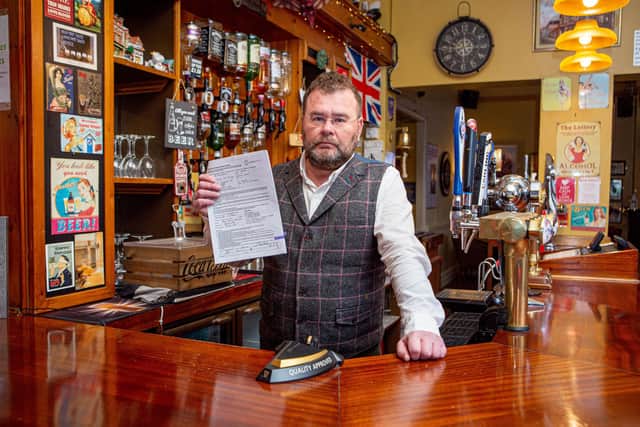 Vladimir Nasadovich with the forged documents at his pub the George and Dragon.
Picture: Habibur Rahman