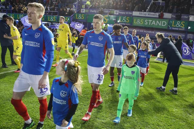 James Bolton (centre) and his Pompey team-mates were instructed not to hold the hands of mascots against Fleetwood on Tuesday night. Picture: PinPep Media/Joe Pepler