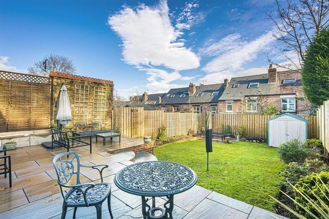 At the back of the house, is a fantastic sized garden which has a lawn area, beds with a variety of well-established plants and two paved patio areas.