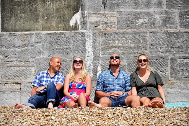 Pictured from left: A group of friends relax in the sun at the Hot Walls in Southsea, Portsmouth. Weather input. People enjoy the hot and sunny weather at Southsea Beach, Portsmouth. © Solent News & Photo AgencyUK +44 (0) 2380 458800