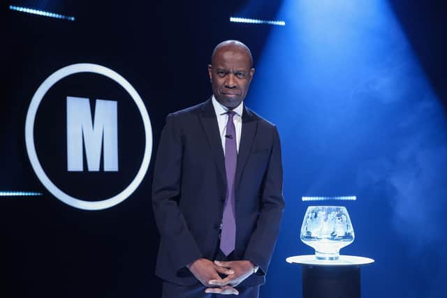 Host Clive Myrie with iconic Mastermind glass bowl trophy
