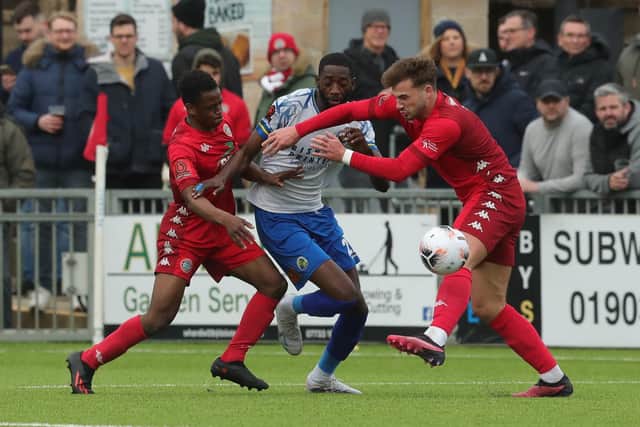 Mo Faal is outnumbered by Worthing defenders. Picture by Dave Haines