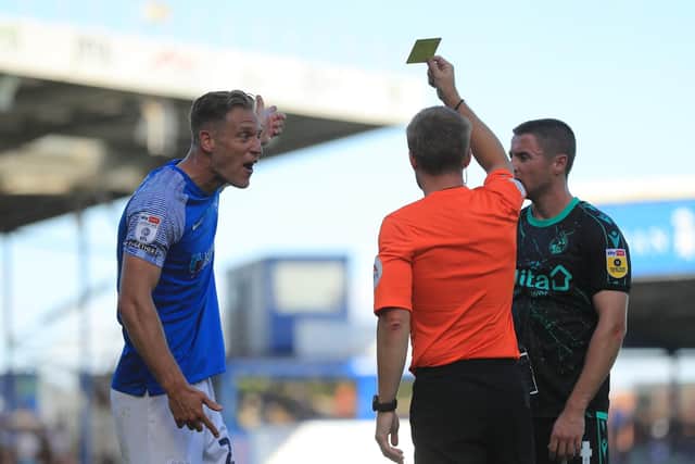 Portsmouth defender Michael Morrison being booked by referee Gavin Ward during the EFL Sky Bet League 1 match between Portsmouth and Bristol Rovers at Fratton Park. Picture: Simon Roe/ProSportsImages.