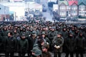 Argentine prisoners of war massed in Port Stanley, capital of the Falkland Islands, after their surrender to the British Falkland Islands Task Force. Photo: PA Wire.
