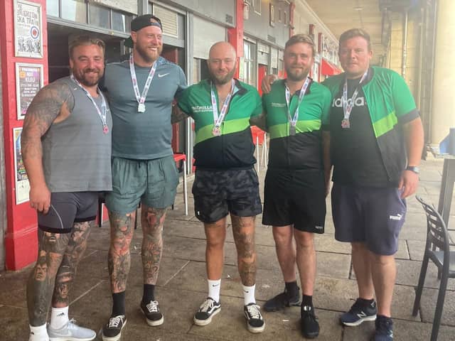 Portsmouth friends Matt Burnett, Sonny Dobson, Sam Sargeant, Shaun Legg and Dave Pike cross the London to Brighton cycle ride finish line in September.