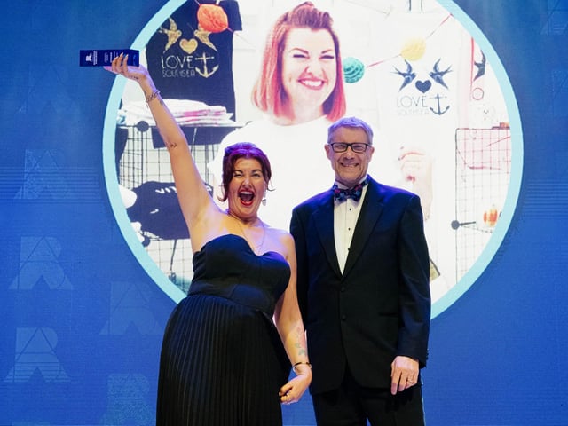 Lulu Whitmore celebrates with Mark Waldron, editor in chief for National World.   Picture: Keith Woodland (270321-338)