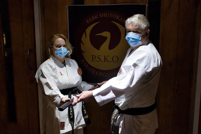 Members of PSKO Havant presented a gift of a Katana of Hope to instructor Michael Fletcher with a certificate and poem. Pictured: Black belt instructor Sam Lewington presenting the gift to Sensei Fletcher in December 2020