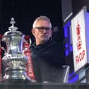 Gary Lineker sits in the BBC Studio next to the FA Cup