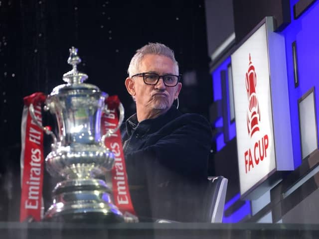 Gary Lineker sits in the BBC Studio next to the FA Cup