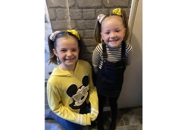 Isabelle Smith, 9 from Havant, has been making and selling scrunchies and raised funds for Children in Need. Pictured: Isabelle, left, with her younger sister Nancy, 5, both wearing the Children in Need scrunchies