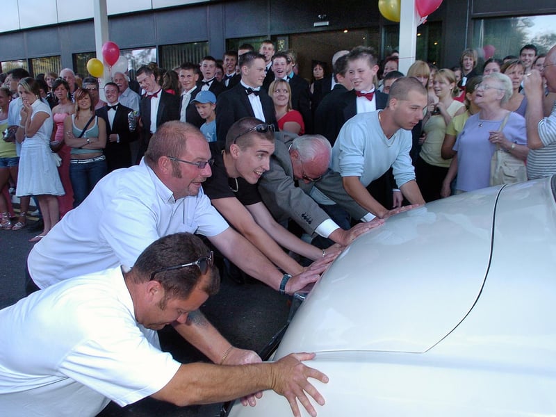 Parents help the arrival of one Roll Royce that couldn't restart, by pushing the vehicle to Springfield Specialist Technology College's prom at Marriott Hotel in June 2006. Picture: (062869-0060)