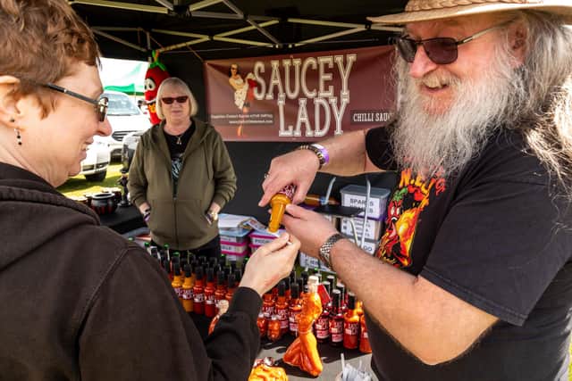 Steve Willott (from Saucy Lady, Reading) gives out a sample to a festival goer at last year's Chilli and Gin Festival. Picture: Mike Cooter (210522)