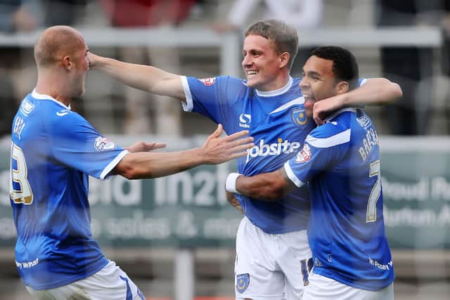 Si Ferry, centre, celebrates scoring for Pompey against Burton. Picture: Joe Pepler