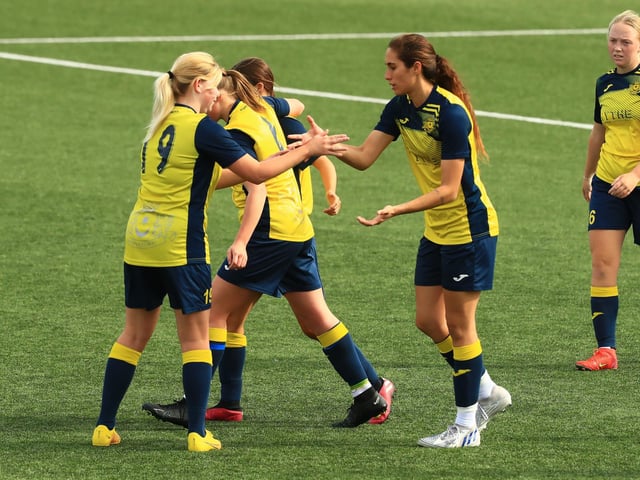 Kau'inohea Taylor congratulated after her second goal. Picture by Dave Haines