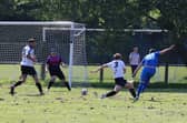 Joe Boxall (blue) scores Paulsgrove's winner against Clanfield. Picture: Sam Stephenson.