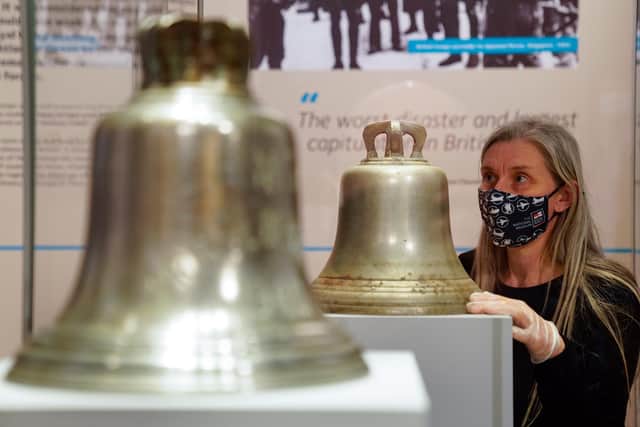 Victoria Ingles, senior curator at the National Museum of the Royal Navy, looks at the ship's bell from HMS Repulse which was sunk along with HMS Prince of Wales after a Japanese air attack on December 10 1941. 842 men lost their lives in what is one of the worst disasters in British naval history. Picture date: Wednesday December 8, 2021.