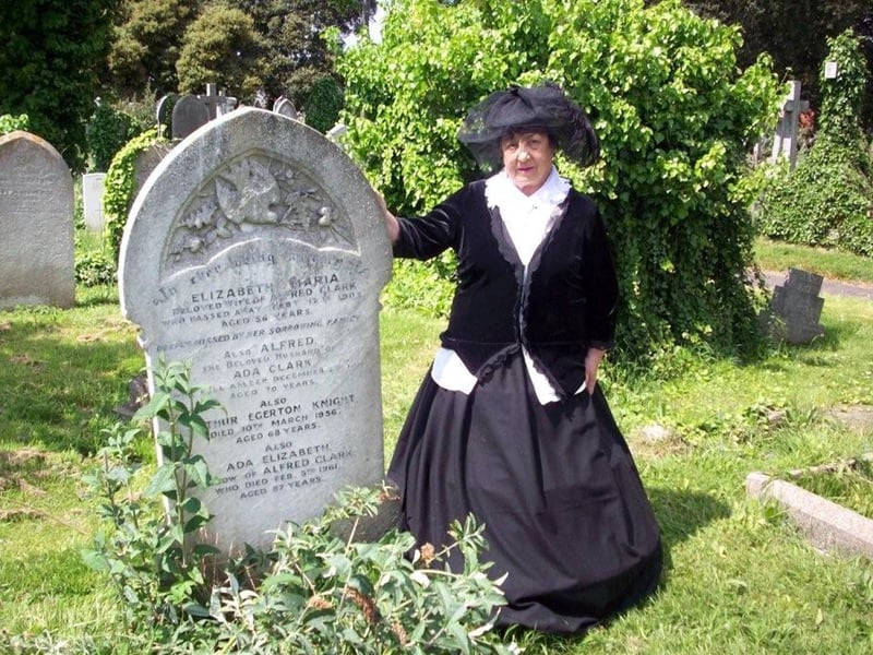 Irene Strange, from the friends of Highland Road Cemetery, dressed in the clothes of the time Arthur Knight was alive as she stands near the ex-Pompey captain's neglected grave,