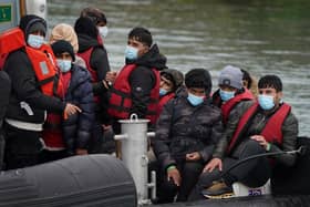A group of people thought to be migrants are brought in to Dover, Kent, onboard a Border Force vessel following a small boat incident in the Channel. Picture date: Wednesday April 13, 2022.