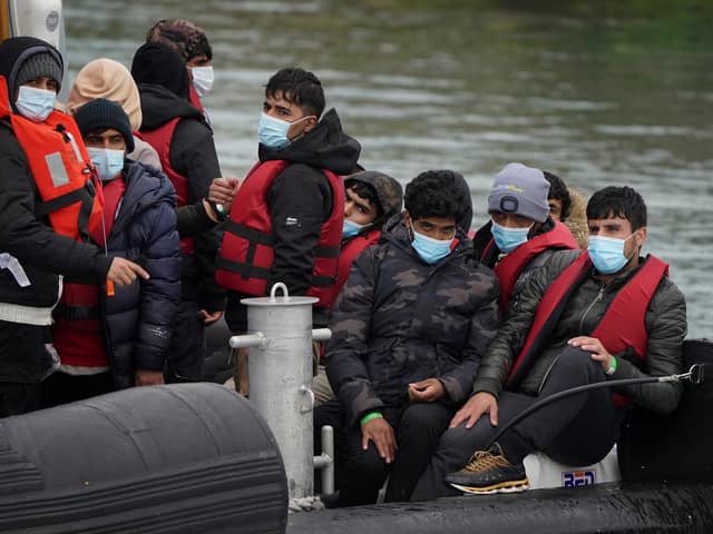 A group of people thought to be migrants are brought in to Dover, Kent, onboard a Border Force vessel following a small boat incident in the Channel. Picture date: Wednesday April 13, 2022.
