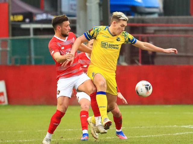Danny Wright holds off Fleet defender Luke O'Neill. Picture by Dave Haines