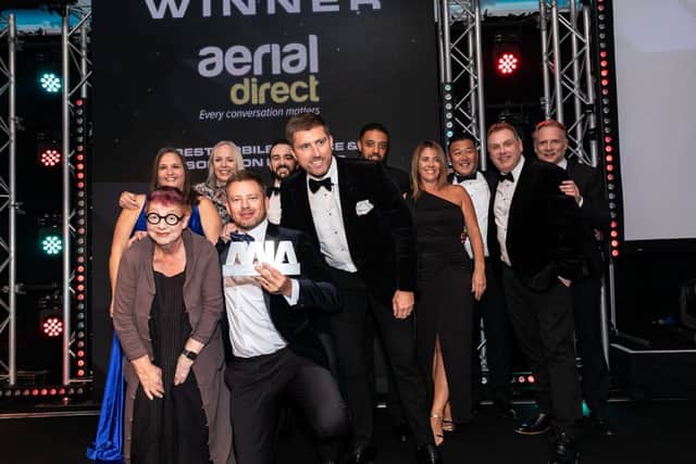 Aerial Direct team receiving their trophy from Jo Brand, the 2024 Mobile Industry Awards host.