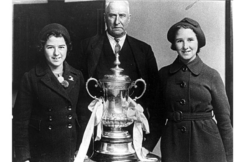 The F.A. Cup with chairman at Fratton Park in 1939.
Sent in by Leslie Smith of Southsea we see Bob Blyth the former chairman of Portsmouth F.C. with the F.A.Cup in 1939. With him are his grand-daughters Jean on the left and Mary Tilbury.