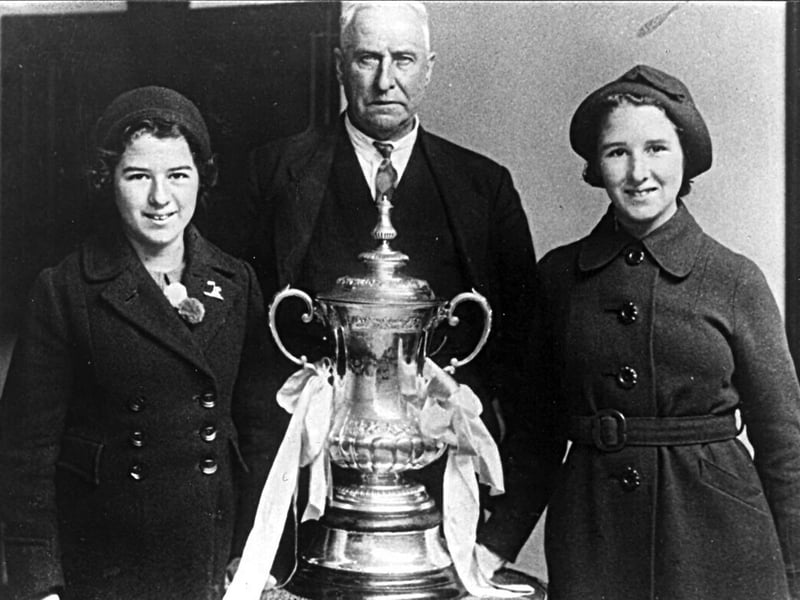The F.A. Cup with chairman at Fratton Park in 1939.
Sent in by Leslie Smith of Southsea we see Bob Blyth the former chairman of Portsmouth F.C. with the F.A.Cup in 1939. With him are his grand-daughters Jean on the left and Mary Tilbury.