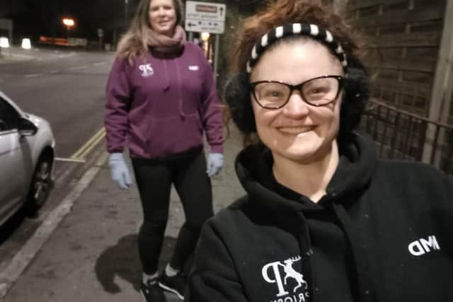 Kat Millmore-Davies (front) and Hesta Dalton doing a night walk on Southsea seafront.