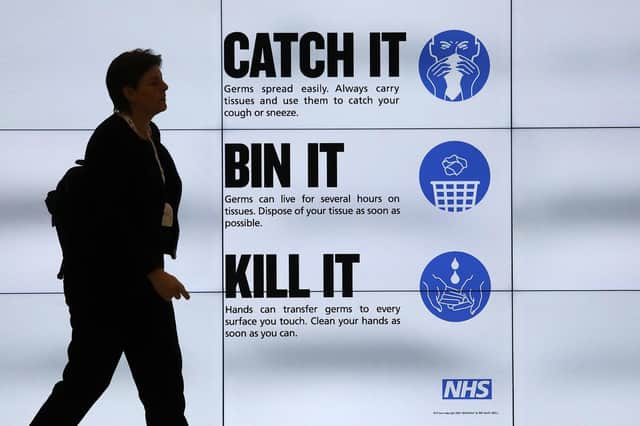 An NHS catch it, bin it, kill it sign on TV screens in the entrance to the QEII Centre in London. PA Photo. Picture date: Thursday March 5, 2020. See PA story HEALTH Coronavirus . Photo credit should read: Philip Toscano/PA Wire
