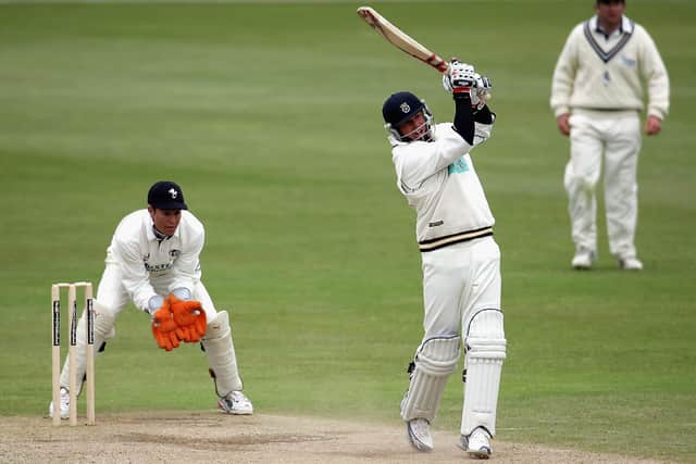 Shane Warne hits a boundary on his way to a maiden first class century for Hampshire at Canterbury in 2005. Photo by Tom Shaw/Getty Images.