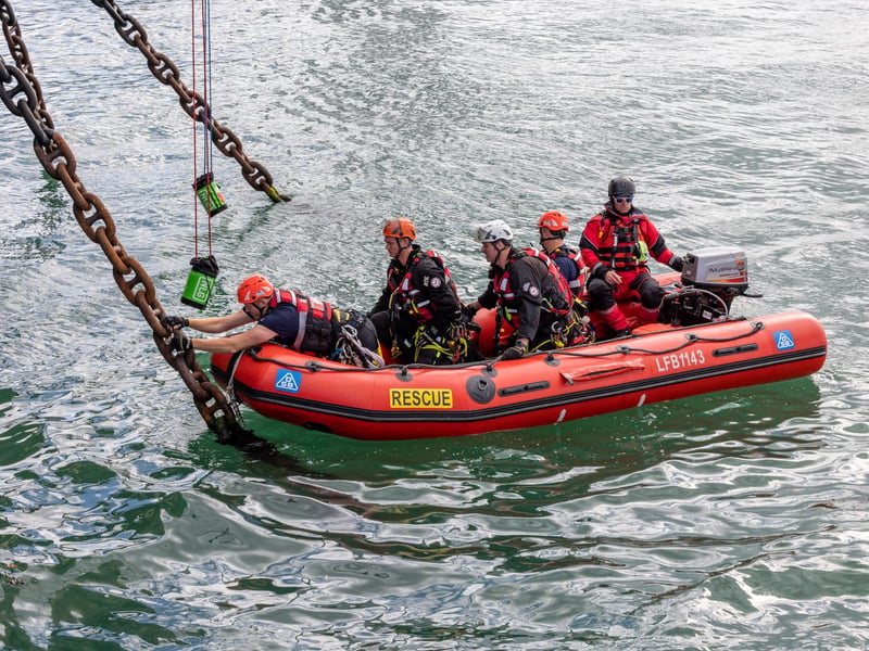 Firefighters practicing rescue from the sea, ascending by rope onto HMS Warrior during the UKRO event at Portsmouth Historic Dockyard. Picture: Mike Cooter (280924)