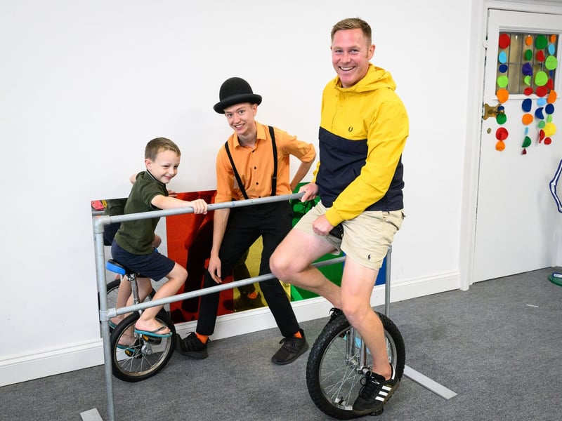 Pictured is: Harry with Dad Rob Franklin trying out the Uni cycles with Chris from Jake's circus.
Picture: Keith Woodland (170721-18)