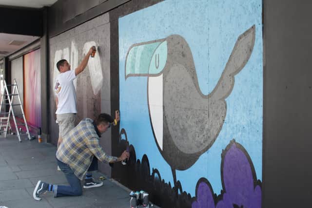 Street artist Fark creating a mural at the first We Create Market. Picture by Ming Wu